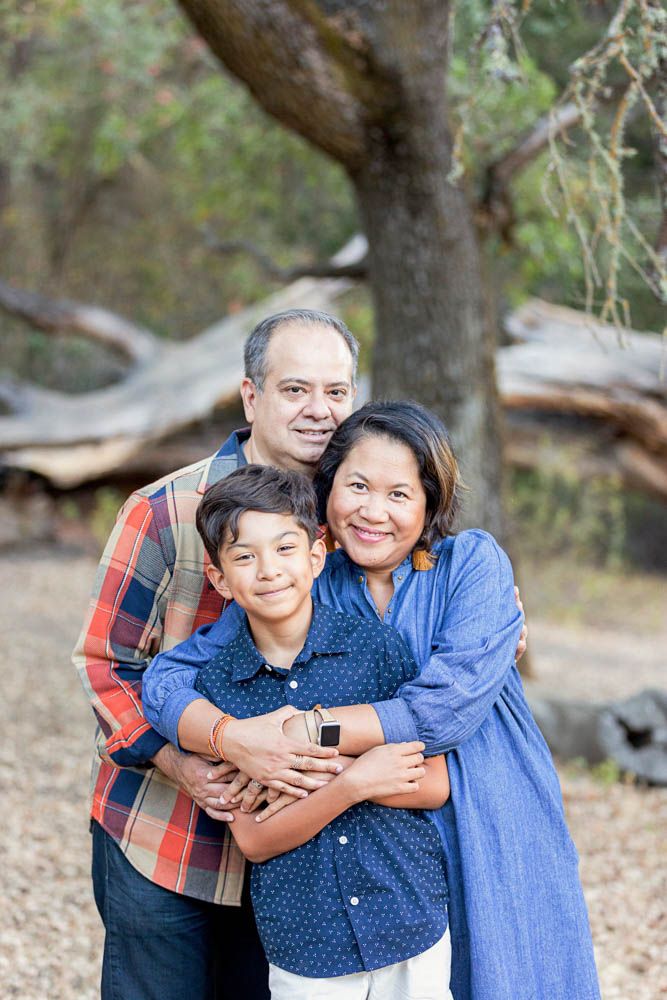 Family of three - mom and dad hugging their son Pose Ideas For Family Of 3, Family Photography 3 People, Family Portrait Of 3, Family If Three Photos, Big Family Photo Shoot Ideas Group Poses Grandparents, Family Of 3 Older Child Photo Ideas, Three Person Family Photos, Photo Poses For Family Of 3, Family Of Three Photo Ideas Older