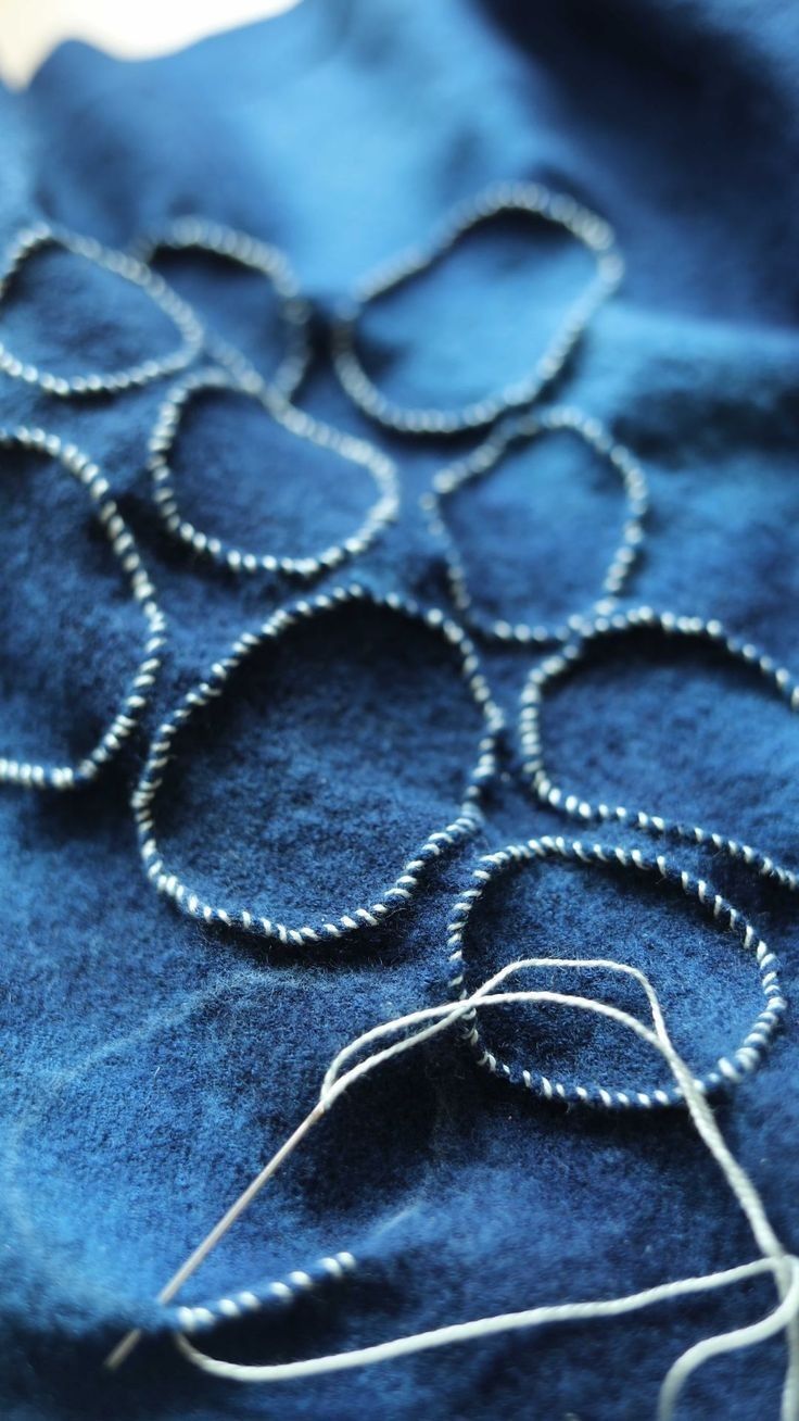 an image of a close up view of a piece of blue fabric with circles on it