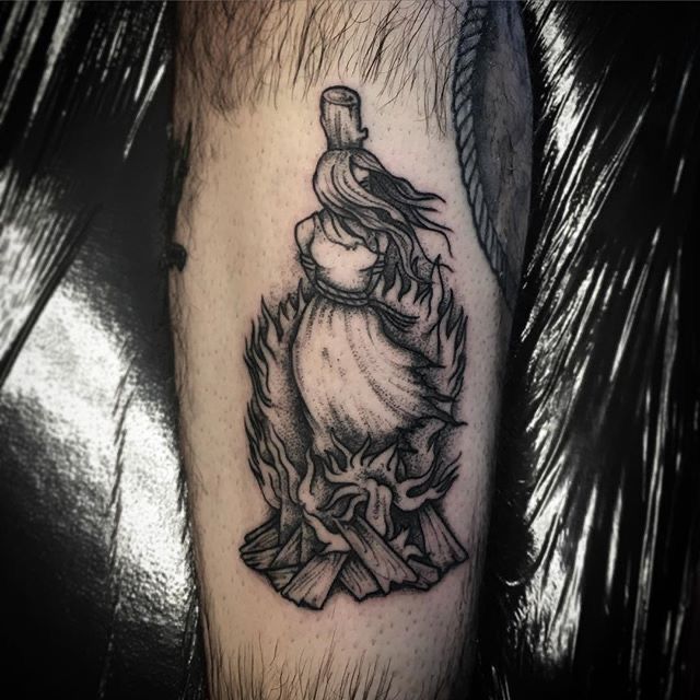 a black and white tattoo on the leg of a man