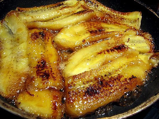 some food is cooking in a pan on the stove top and ready to be eaten