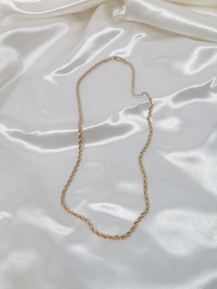 Our 18k Gold Filled Rope Chain Necklace is the perfect layering piece to accentuate any style. This lightweight rope chain pairs beautifully with other chain necklaces or pendants--We love it with our Anabella Necklace. This essential necklace is a must-have for every fashion lover! Details 18k Gold Filled 18in 20in, 22in in Length 2.5mm width model wearing 20in Tarnish-resistant, water-resistant, and safe for sensitive skin Elegant Rope Chain Necklace With Adjustable Snake Chain, Long Figaro Chain Necklace As Gift, Figaro Chain Long Necklace As Gift, Gold Rope Chain Necklace With Figaro Style, Elegant Gift Rope Chain Necklace With Adjustable Chain, Elegant Rope Chain Necklace For Gift, Gift Rope Chain Necklace With Figaro Link, Gold Link Rope Chain Necklace For Gift, Gold Link Rope Chain Necklace Perfect For Gift