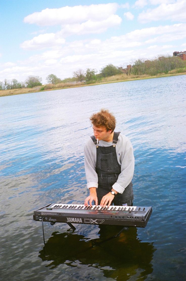 a man is playing an electronic keyboard in the water