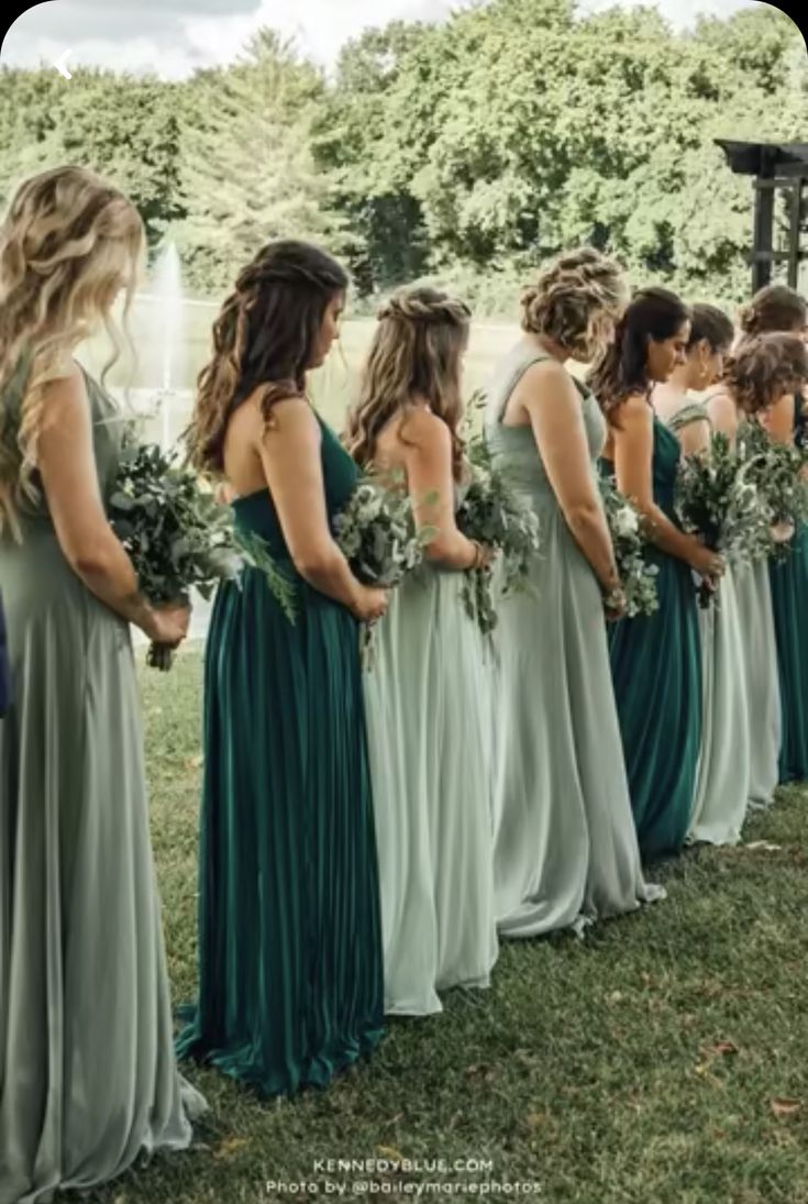 a group of women in long dresses standing next to each other