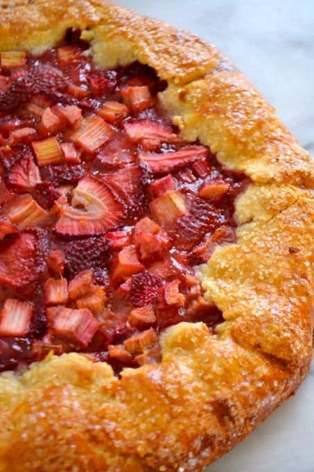 a strawberry pie sitting on top of a white counter