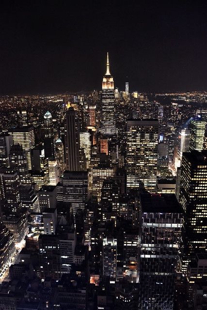 an aerial view of new york city at night from the top of the empire building