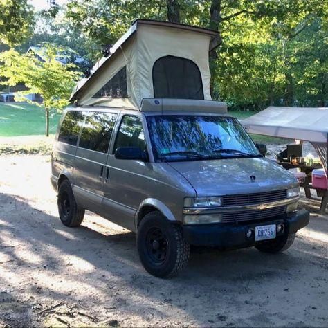 a van parked in front of a tent