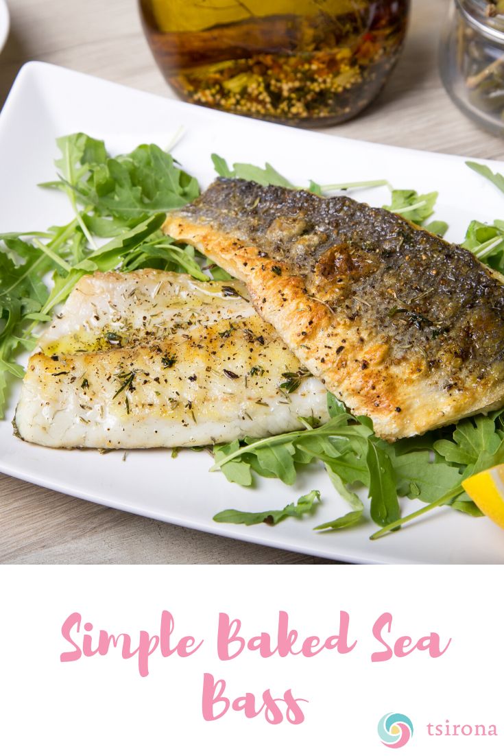 a white plate topped with fish and greens