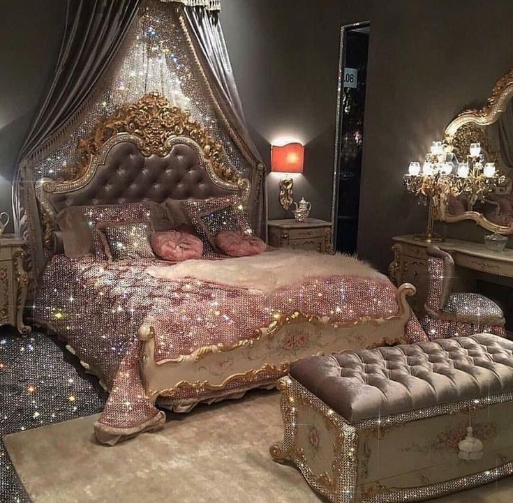 a fancy bedroom is decorated in pink and gold colors with an upholstered canopy bed