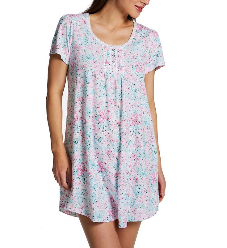 Cute short nightshirt with delightful floral prints, wonderful details, and pure cotton comfort. Wide rounded neckline with applique border sewn onto front edge. Decorative ruched button panel with applique, small satin bow at top, and four polished genuine shell flower-shaped buttons. Interior of button panel is lined with fine mesh for comfortable contact with skin. Short cap-style sleeves with ruching at shoulder. Fit flares slightly to curved hem. Tag sewn inside of back can be used as a han Comfortable Cotton Nightgown For Spring, Relaxed Fit Nightgown For Summer, Summer Nightgown With Relaxed Fit, Comfortable Tops For Spring Bedtime, Relaxed Fit Nightgown For Summer Nights, Comfortable Tops For Bedtime In Spring, Summer Nightgown With Relaxed Fit For Overnight, Comfortable Spring Bedtime Tops, Casual White Sleepwear For Hospital