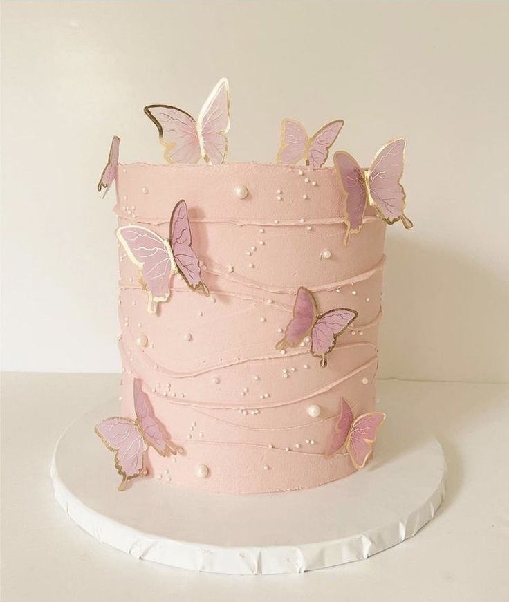 there is a pink cake with butterflies on it