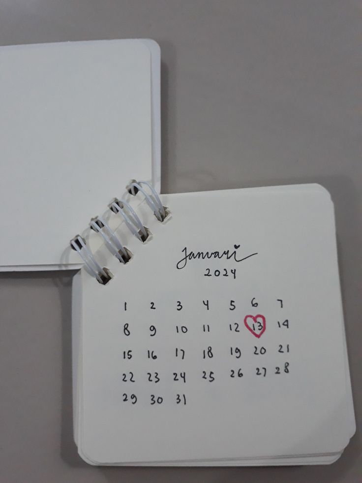 a calendar with a heart on it and a notepad attached to the front cover