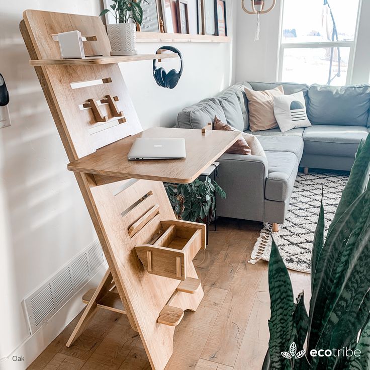 a living room filled with furniture and a wooden shelf next to a plant on top of a hard wood floor