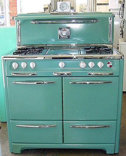 an old fashioned green stove in a kitchen