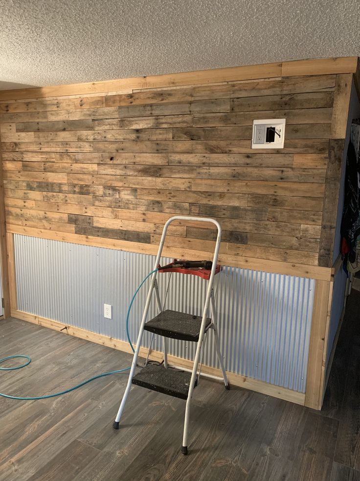 a ladder that is sitting in front of a wooden wall