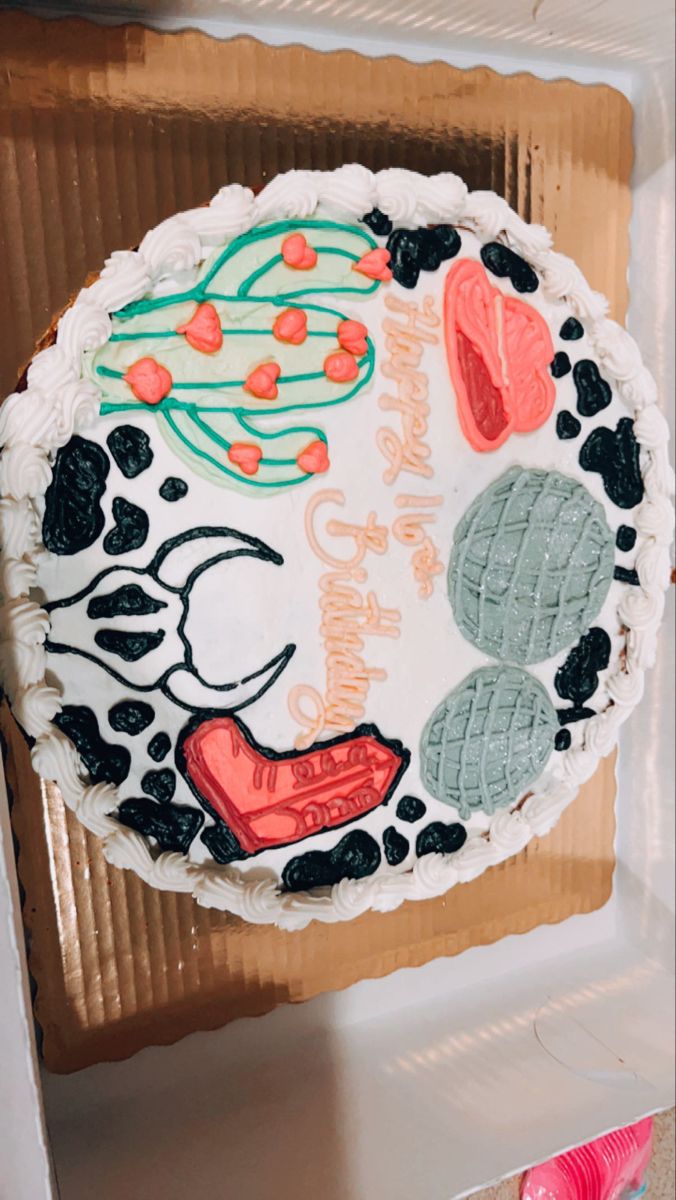 a decorated cake sitting on top of a cardboard box