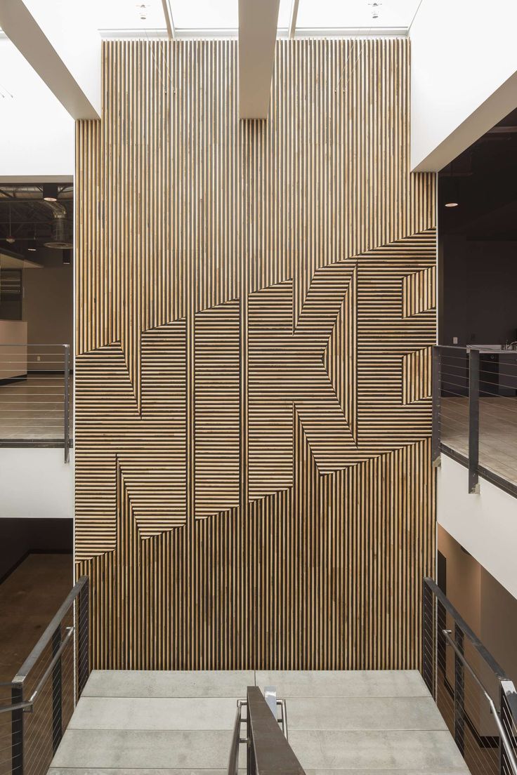 the interior of an office building with wooden panels on the wall and stairs leading up to it