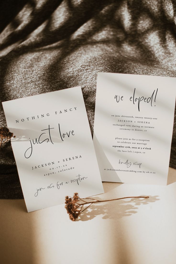 two wedding cards sitting on top of a bed next to each other with the word just love written on them