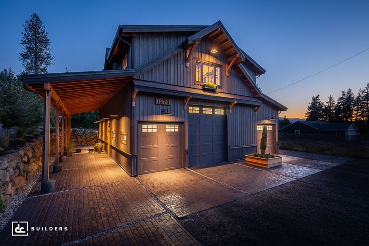 a large garage with lights on in front of it