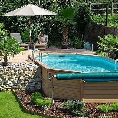 an above ground swimming pool surrounded by landscaping