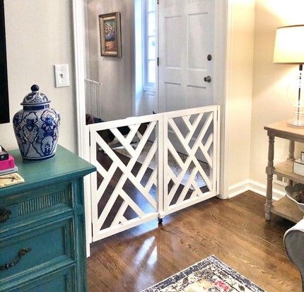 a blue and white vase sitting on top of a wooden table next to a doorway