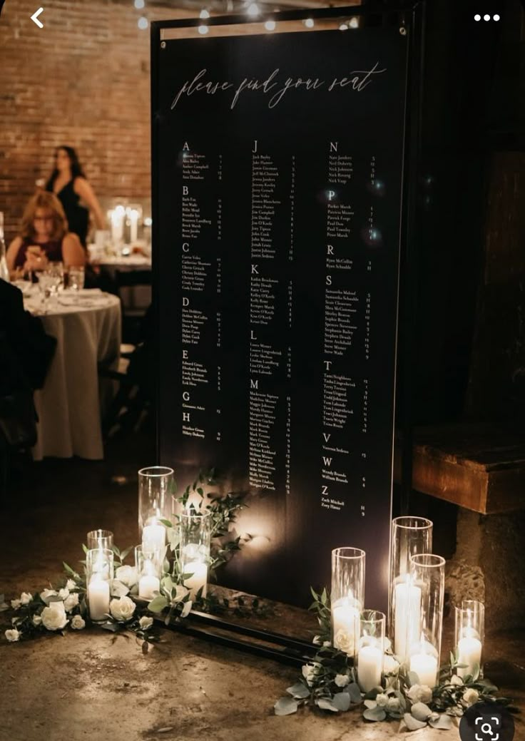 a table with candles and flowers on it next to a sign that says your guests