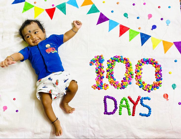 a baby laying on top of a white blanket next to a sign that says 90 days