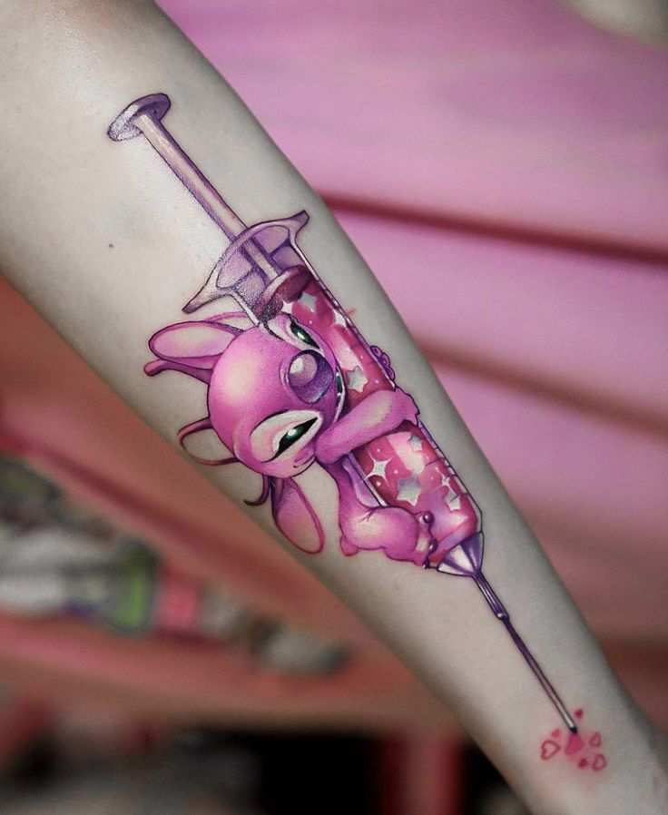 a cartoon character holding a pink umbrella tattoo on the arm