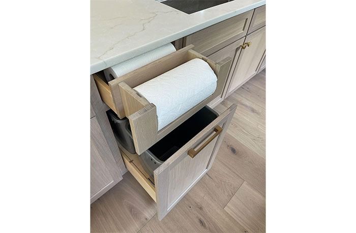 a roll of toilet paper is sitting in a drawer on the counter next to a sink