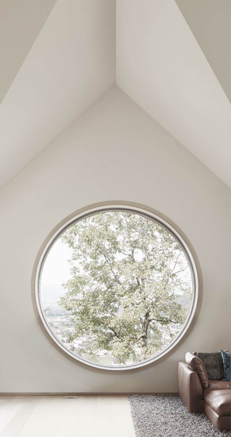 a living room with a large round window