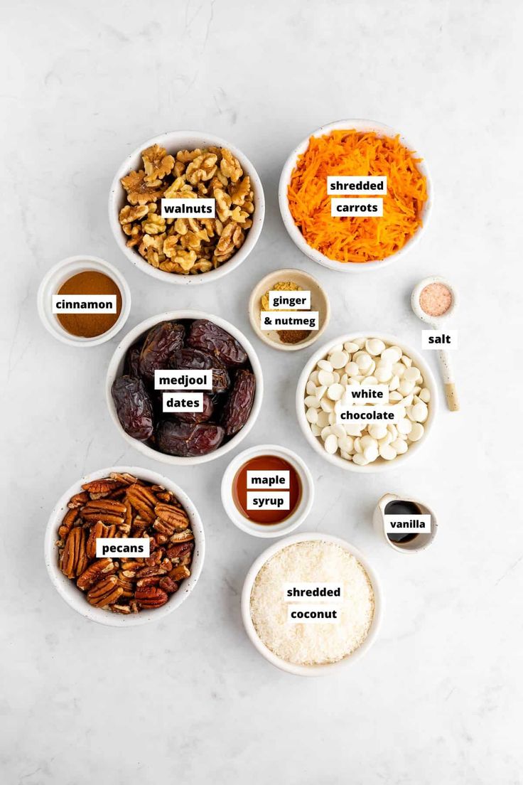 bowls filled with different types of food on top of a white countertop next to spices and seasonings