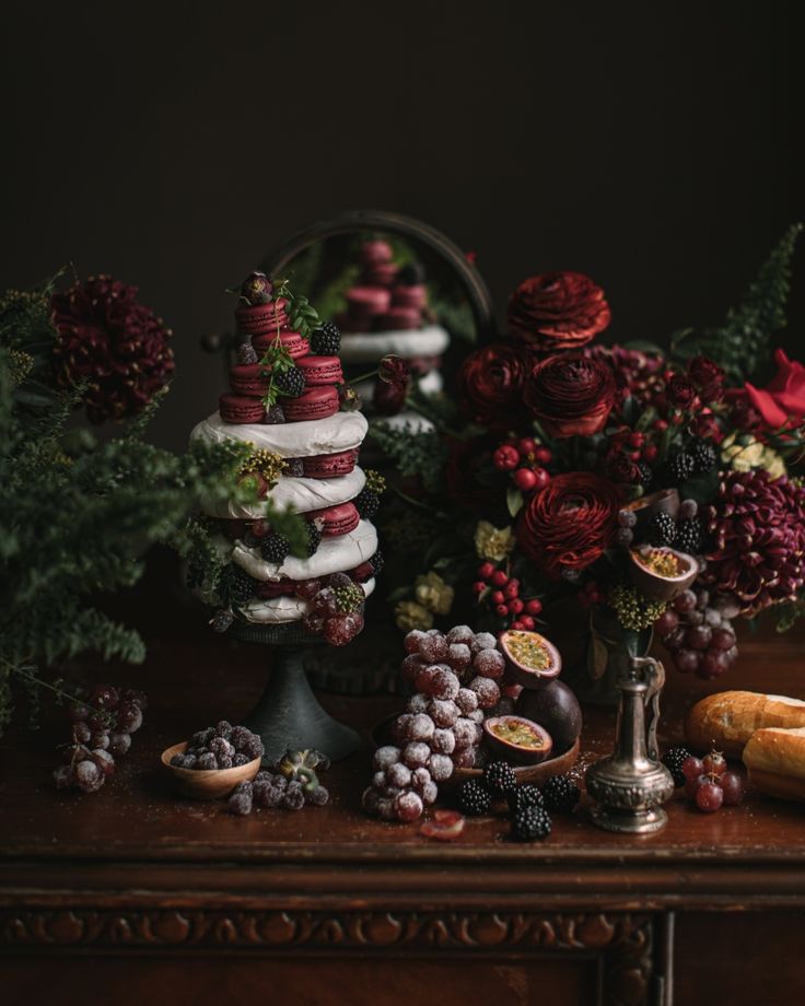 a table topped with lots of different types of food and flowers on top of it