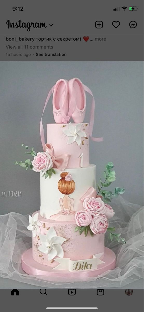 a three tiered cake decorated with pink flowers and ballet shoes