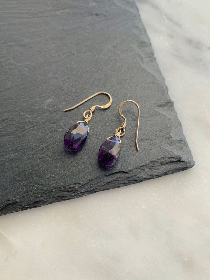 "These gemstone drop earrings are carefully handcrafted with genuine natural amethyst pear shaped briolette drops on 14k gold filled or sterling silver ear wires.  M A T E R I A L S * & * S I Z E * Natural gemstones * Material is 14k gold filled or sterling silver * Drop Length: 12mm * Total Length: 26mm (approximately 1\") P R O D U C T I O N * T I M E S All items in my shop are handmade. Production time will vary depending on sales volume. Please message me if you have delivery estimate questi Everyday Amethyst Dangle Earrings, Purple Birthstone Dangle Earrings, Silver Amethyst Dangle Earrings, Silver 14k Gold-filled Gemstone Earrings, Nickel-free Amethyst Dangle Earrings, Chic Bracelet, Gold Filled Earrings, Long Pendant, Holiday Shopping