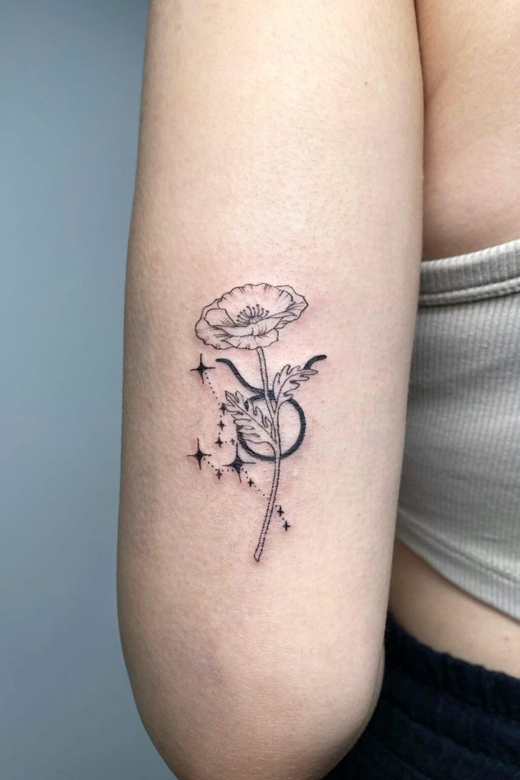 a woman's arm with a flower tattoo on the left side of her body