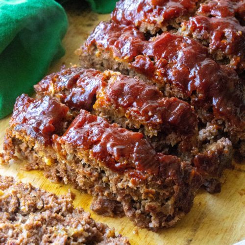 slices of meatloaf sitting on top of a cutting board