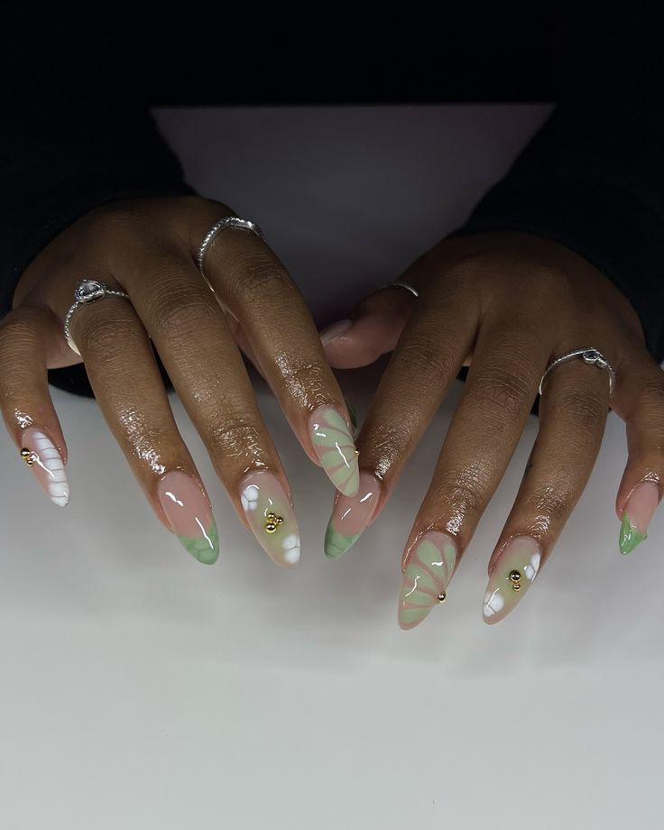 🌿🐚🥝 @shopagaloreco products used: *bling gel *irish creme *sativa, sage, ultra white *bling gel *diamond steel top coat use code ‘ALEXIA10’ at checkout 🤎 #nails #nailart #naildesign #nailideas #nailinspo #greennails #bloomingnails #3dnailart #3dnails #gelx #gelxnails #gelxinspo #gelxnailtech #cltnails #cltnailtech Lilac And Sage Nails, Sage Green Marble Nails, Sage Nails Acrylic, Fall Nails Olive Green, Sage Green Nail Designs, Green Nails With Gold, White Stiletto Nails, White Nails With Gold, Jade Nails