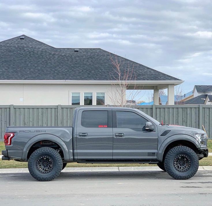 a gray truck parked in front of a house