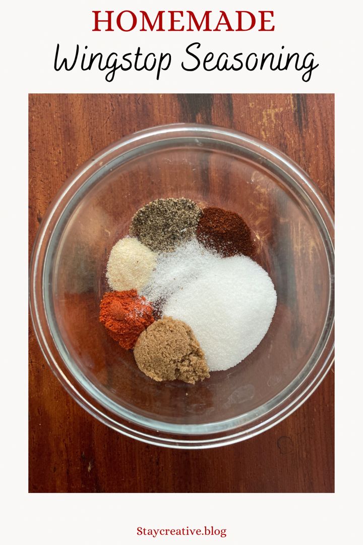 the ingredients for homemade wingstop seasoning in a glass bowl on top of a wooden table