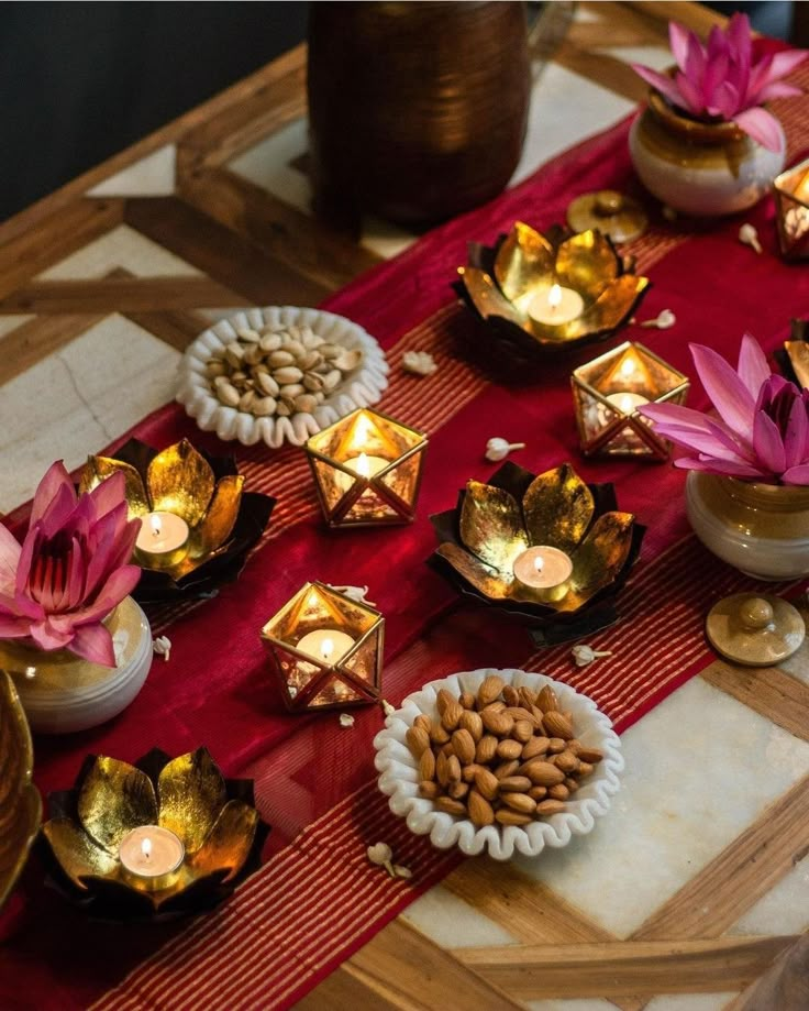 a table topped with bowls filled with flowers and candles