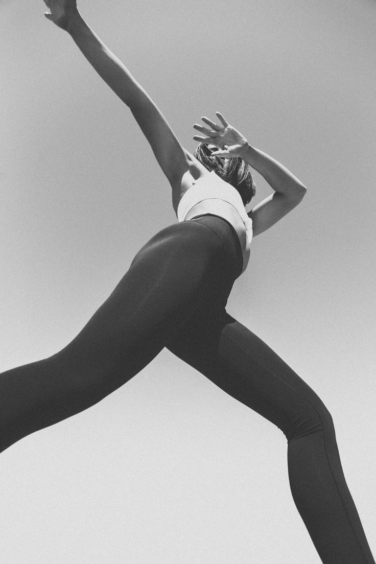 black and white photograph of a woman in mid air