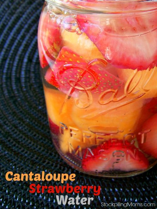 a jar filled with lots of fruit sitting on top of a blue tablecloth covered floor