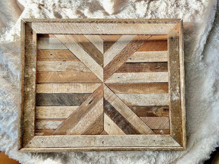 a wooden frame sitting on top of a white blanket