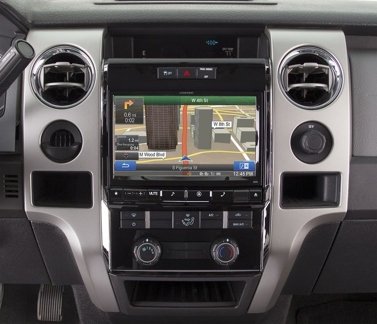 the interior of a car with an entertainment system and navigation screen in it's center