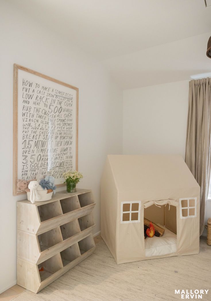 a room with a book shelf and a tent on the wall