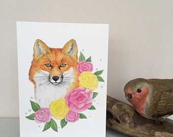 a card with an image of a fox and flowers on it next to a bird