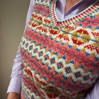 an older woman wearing a colorful knitted sweater