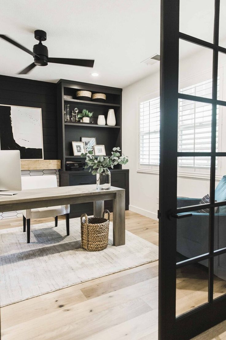 a living room filled with furniture and a computer desk