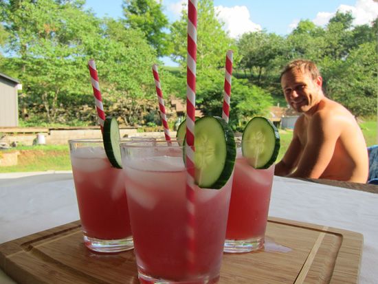 two glasses filled with cucumber and watermelon on a table