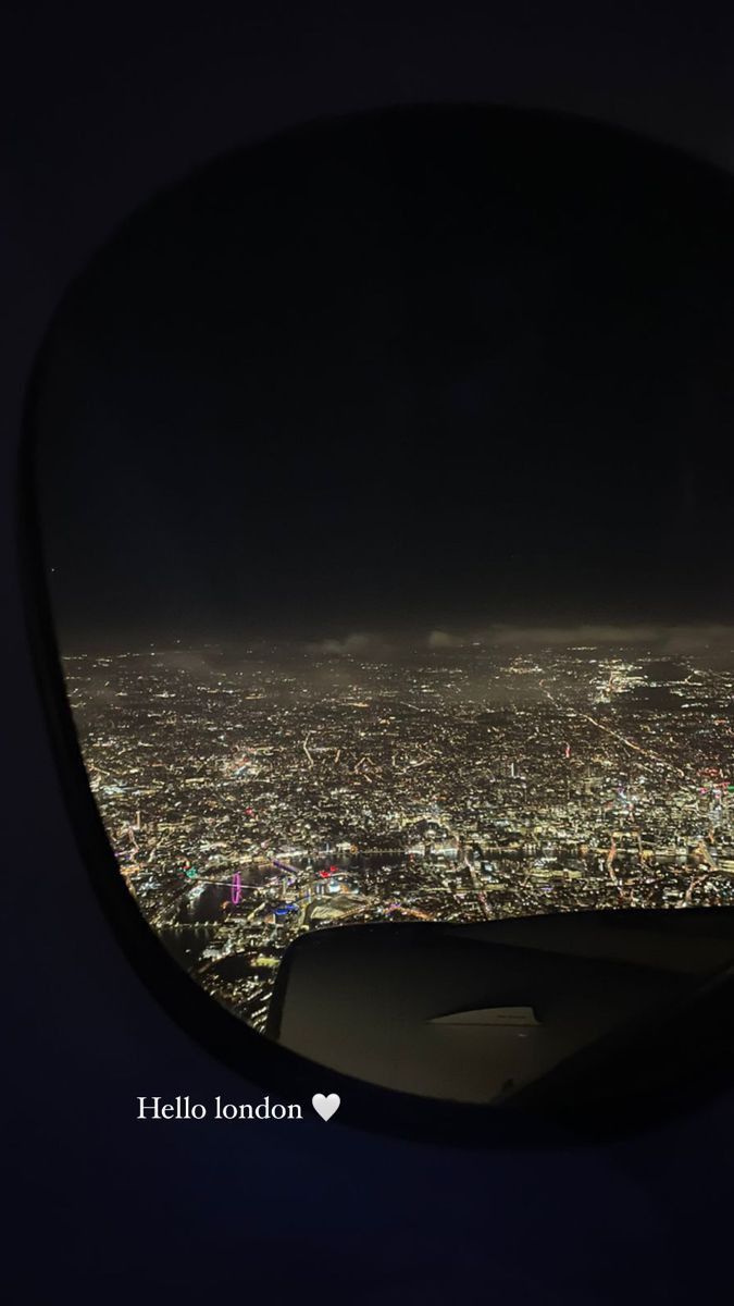 the view from an airplane window at night, looking down on a cityscape