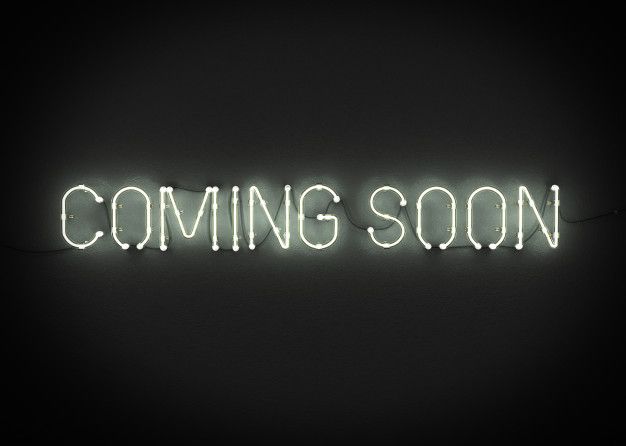 a neon sign that reads coming soon